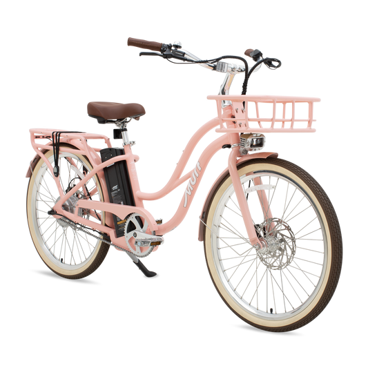 A peach-colored Murf Gigi eBike parked on a sandy beach with the ocean in the background.