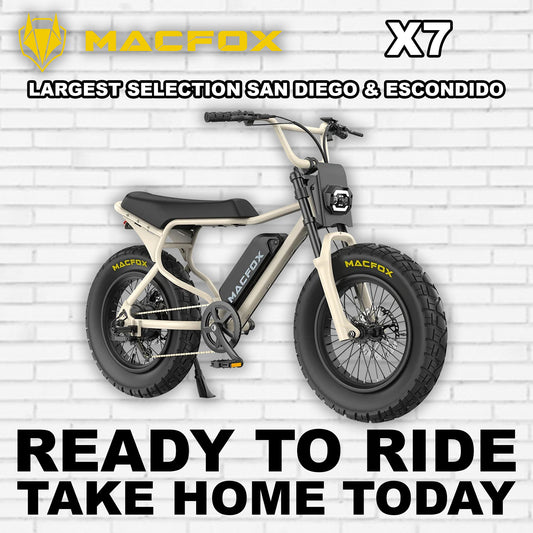 Macfox X7 eBike in Desert Beige color, side view, parked on rugged terrain
