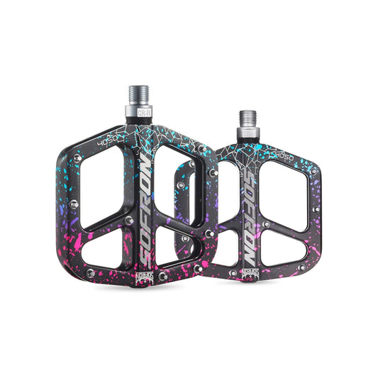 Alloy eBike pedals in a rainbow camouflage pattern, shown from a side angle on a white background.