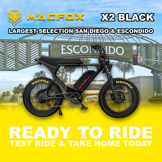Black Macfox X2 eBike side view, showcasing rugged frame, thick tires, and modern design against a plain background.