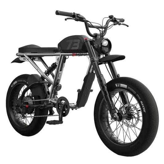Side view of the eMOTO eBike Super73 R Brooklyn SE in a showroom, showcasing its sleek black frame, thick tires, and modern design.