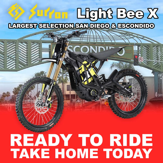 Black eMOTO Surron Light Bee X electric bike, side view, ready to ride, against a plain background