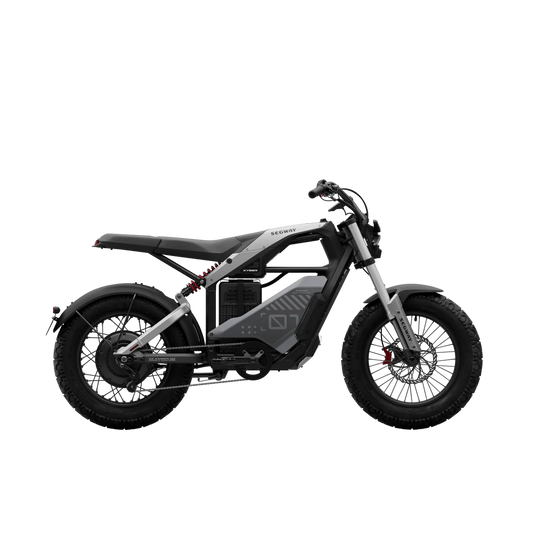 A black eMOTO Segway Xyber electric bike parked on a paved surface, showcasing its rugged frame, thick tires, and modern design.
