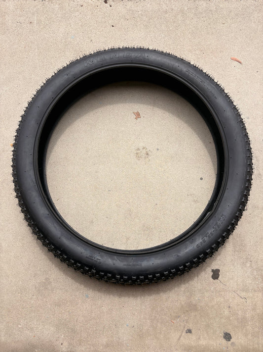 Electric fat tire bike featuring 26x4 inch Kenda Juggernaut tires, shown in a side profile against a plain background.