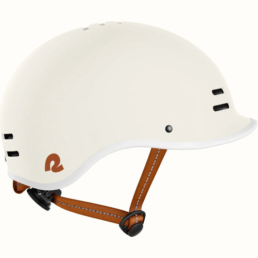 Matte eggshell Retrospec Remi eBike helmet, side view, with adjustable straps and ventilation holes