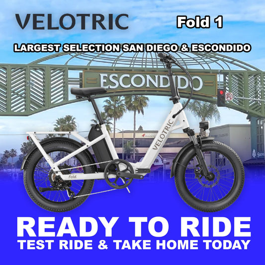 Pearl white Velotric Fold 1 eBike, folded and ready to ride, shown against a plain background.