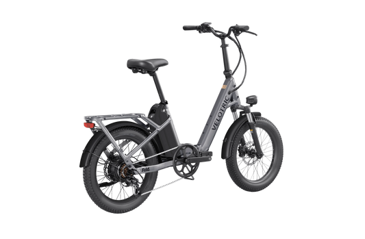 Velotric Fold 1 electric bike in Stone Gray, folded for compact storage, side view on a white background