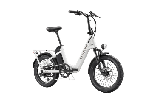 A compact Velotric Fold 1 eBike in a folded position, featuring a sleek frame, small wheels, and integrated battery, designed for portability and urban commuting.