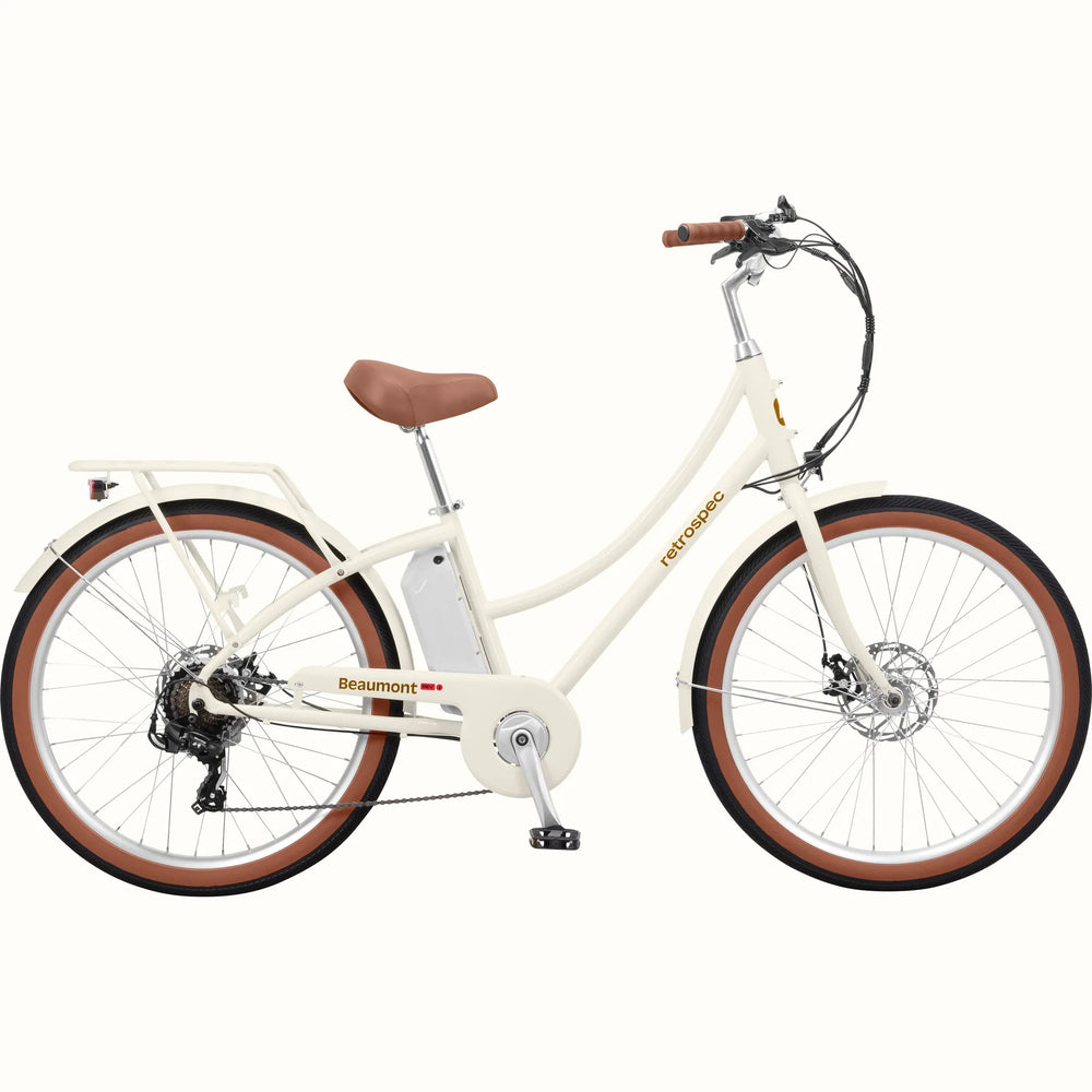 Retrospec Beaumont Rev 3 electric bike in eggshell color, side view, featuring step-through frame, rear rack, and brown saddle and grips.