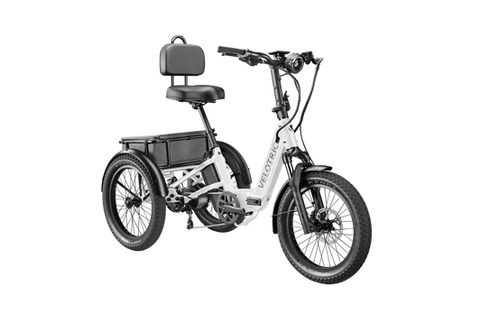 Side view of a Velotric Triker electric trike in matte gray, showing three wheels, a step-through frame, rear cargo basket, and ergonomic handlebars.