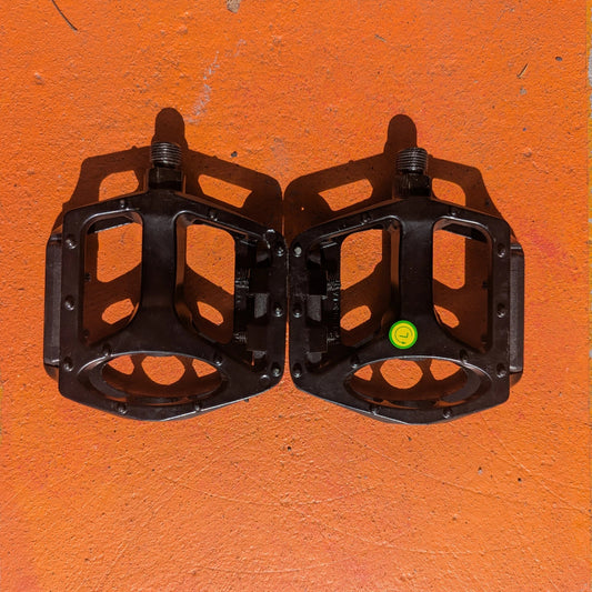 A metal bicycle pedal in Style 1 design, featuring a sleek, durable construction with a textured surface for grip.