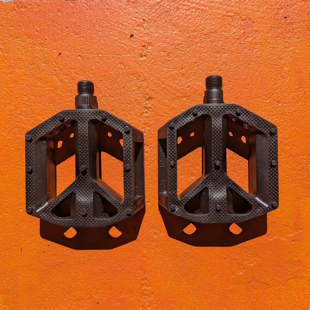 Black nylon bicycle pedal, Style 1, shown from a side angle on a plain background.