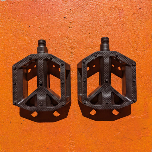 Black nylon bicycle pedal, Style 1, shown from a side angle on a plain background.