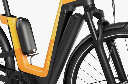 Urtopia Fusion GT eBike in Vital Orange, side view highlighting frame design, wheels, and integrated components against a white background.
