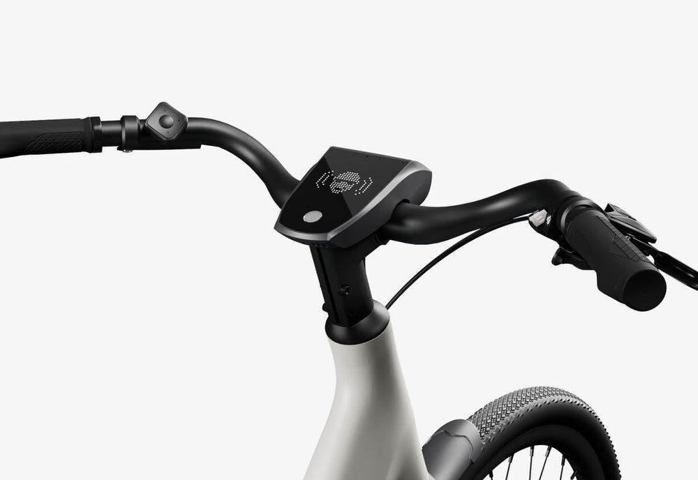 Side view of the Urtopia Carbon 1 Step Thru eBike in a modern setting, showcasing its lightweight carbon frame, step-through design, and integrated display.