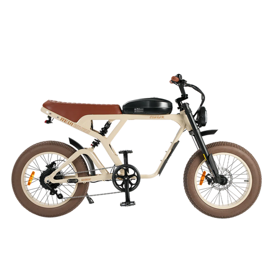 A sand-colored eBike Revi Cougar electric bicycle shown from the side, highlighting its frame, wheels, and battery.
