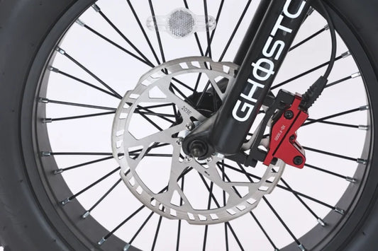 Side view of the eBike Ghostcat F3.3 in a studio setting, showcasing its sleek frame, large tires, and integrated battery.