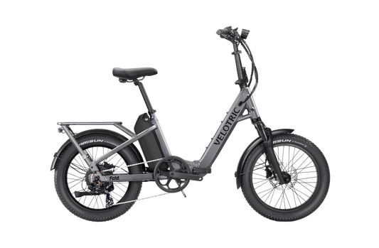 Velotric Fold 1 Plus electric bike in Stone Gray, shown folded for compact storage.
