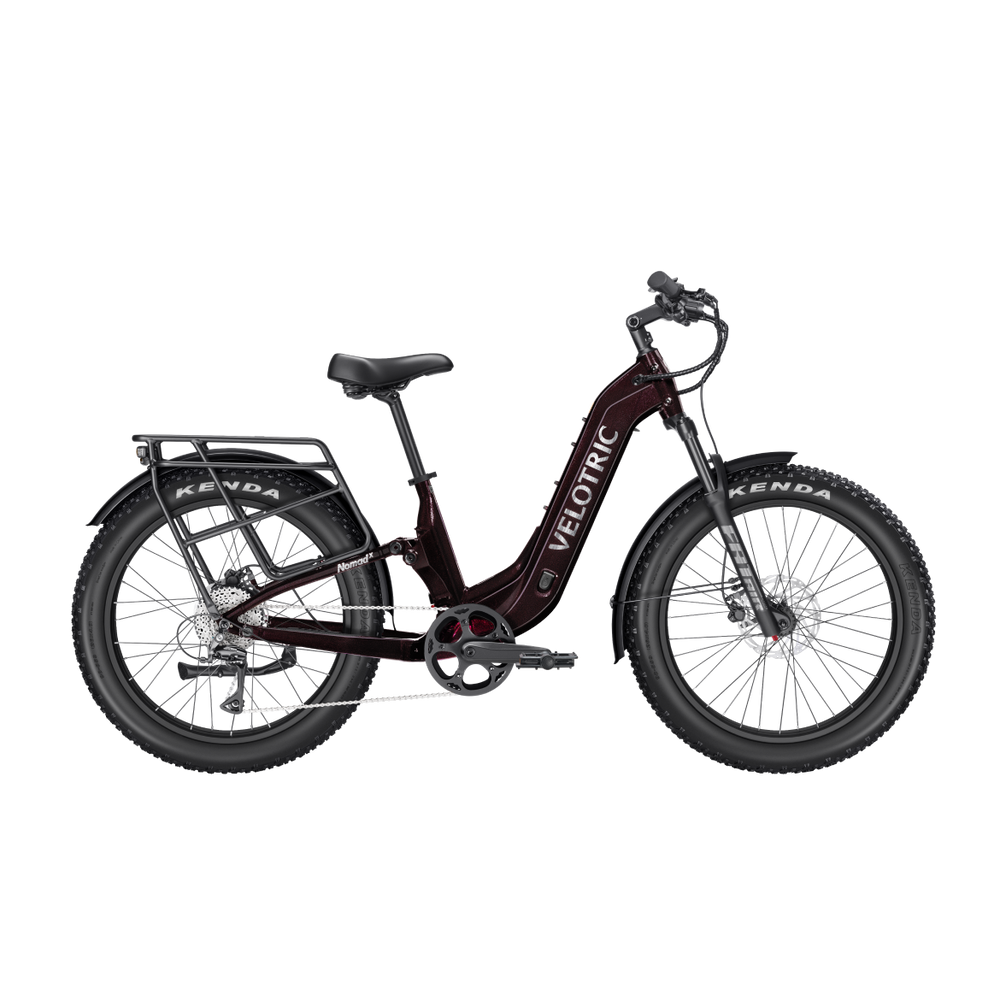 A Velotric Nomad 2X Step-Thru eBike in a side view, showcasing its sturdy frame, wide tires, integrated battery, and step-thru design.