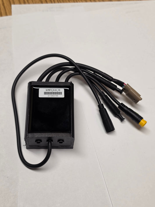 A black Super73 DCDC converter for eBikes, rectangular with labeled input and output terminals, shown on a white background.