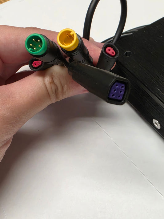 Close-up view of the Super73 DCDC Converter (Version 2) for eBikes, showing the black rectangular unit with attached wiring and connectors on a white background.