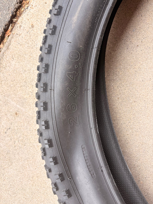 A black 26x4 Chao Yang fat tire mounted on an eBike wheel, showcasing the tread pattern and sidewall branding.