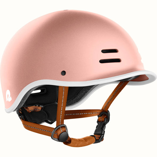 Rose gold Retrospec Remi eBike helmet, side view, with adjustable straps and ventilation holes