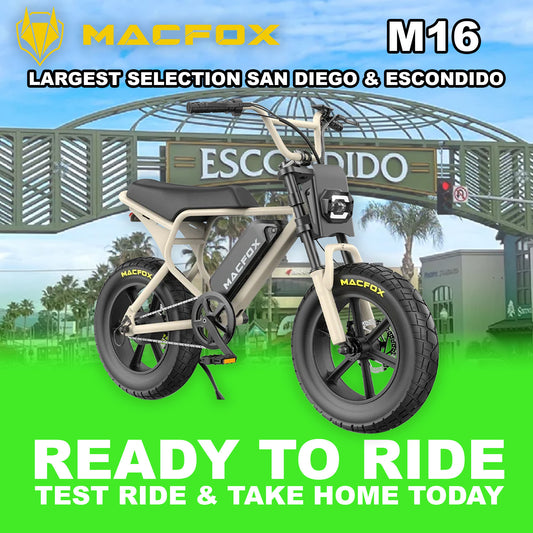 Macfox M16 eBike in desert beige color, side view, parked on rugged terrain with a rocky background
