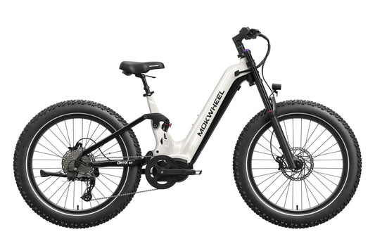 A person rides a Mokwheel Onyx ST eBike in a park, with a panda plush toy attached to the rear rack.