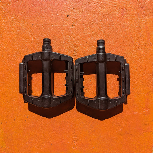Close-up of metal eBike pedals in Style 2 design, featuring a textured surface and sturdy construction, photographed against a plain background.