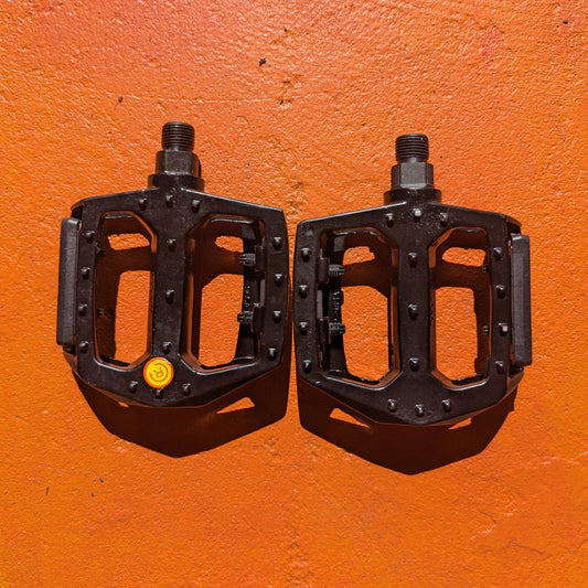 Metal eBike pedals in Style 3 design, featuring a textured surface and sturdy construction, shown from an angled view against a plain background.