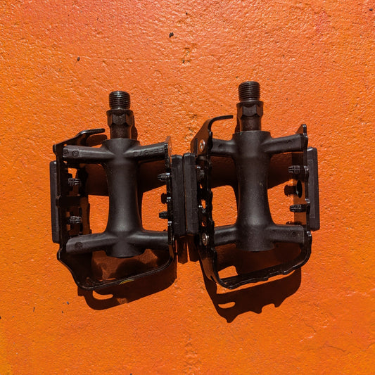 Metal eBike pedals in Style 7 design, featuring a sturdy, textured surface and open frame for enhanced grip and durability, shown against a plain background.