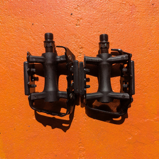 Close-up view of metal eBike pedals in Style 7, showcasing a sturdy, textured surface with a modern, angular design and reflective accents.