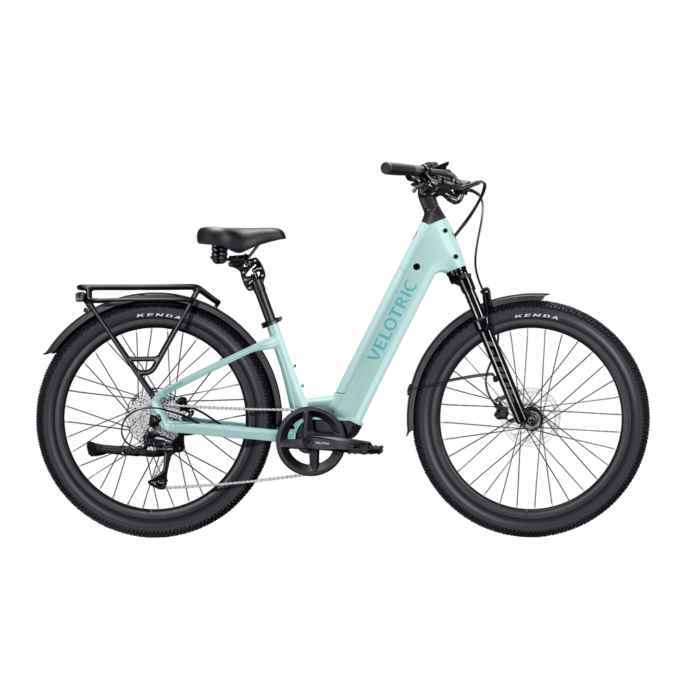 A mint green Velotric Discover 3 eBike shown from a side angle, highlighting its step-through frame, integrated battery, and upright handlebars.