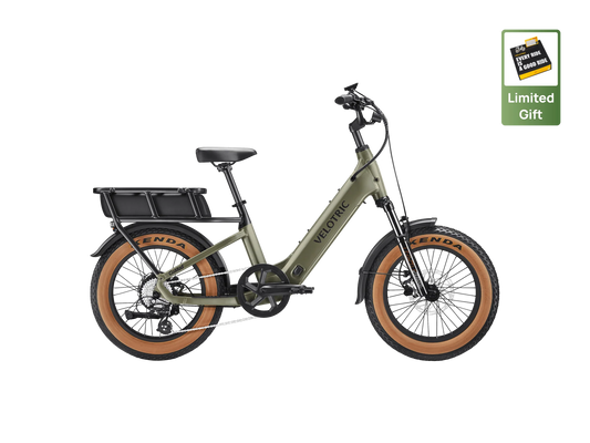 A Velotric GoMad eBike in Sage color, shown from a side angle, highlighting its sturdy frame, thick tires, and integrated battery.