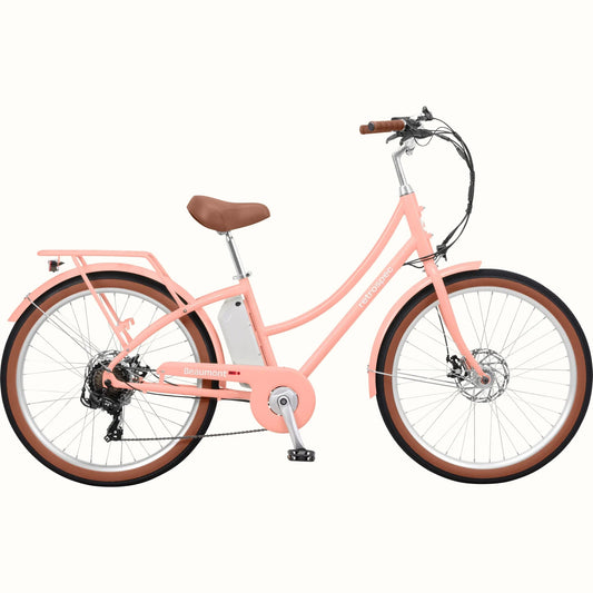 Blush pink Retrospec Beaumont Rev 3 electric bike with step-through frame, brown seat, and matching brown handlebar grips, shown on a white background.