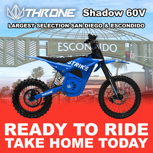 Blue eMOTO Strike Shadow SX 60V electric motorcycle, side view, parked on a plain background