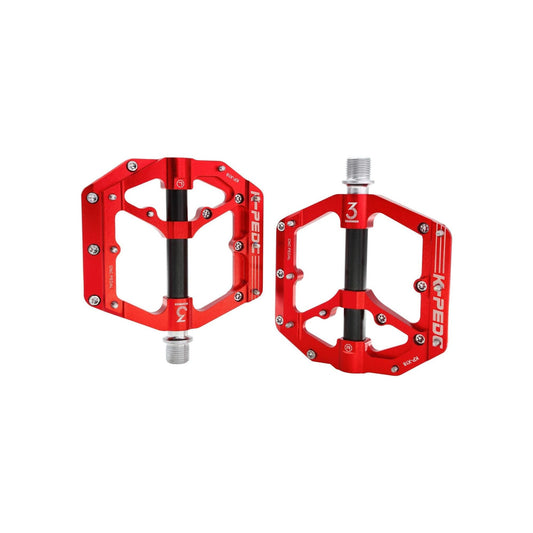 Red and black alloy bicycle pedal with textured surface, shown on a black background.