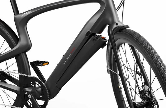 Side view of the Urtopia Carbon 1 Pro eBike showcasing its sleek black carbon fiber frame, integrated battery, and minimalist design against a white background.