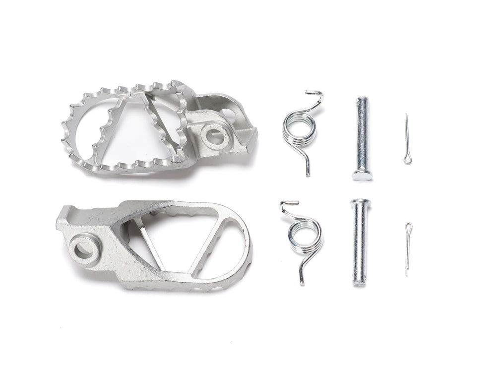Stomp Ebox stainless steel foot peg kit, showing two durable, textured metal foot pegs with mounting hardware on a white background.