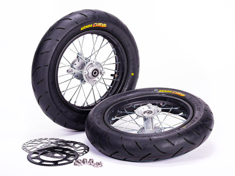 Stomp Ebox Supermoto Wheel Set 12-12, black alloy wheels with silver spokes, displayed side by side on a white background.