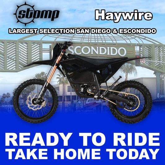 Stomp Haywire eMOTO Black R2R electric dirt bike, side view, black frame, rugged tires, modern design