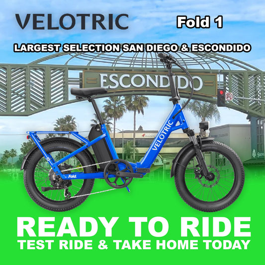 Electric blue Velotric Fold 1 eBike, folded and ready to ride, shown from the side against a plain background.