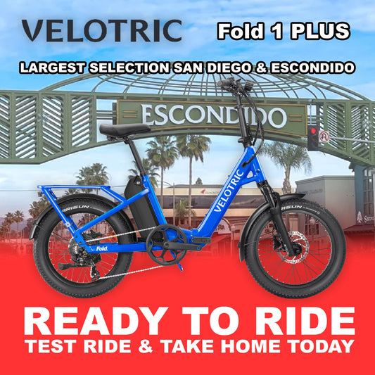 Electric blue Velotric Fold 1 PLUS eBike, folded and ready to ride, shown from the side against a plain background.