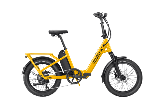 Velotric Fold 1 Plus electric bike in Mango color, shown folded for compact storage.